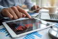 Hands interact with tablet displaying financial trends, highlighting analysis Royalty Free Stock Photo