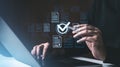 Hands interacting with digital documents and a checkmark icon on a background, symbolizing online approval and verification