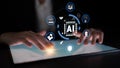 Hands interacting with a digital tablet displaying artificial intelligence icons and symbols, representing technology Royalty Free Stock Photo