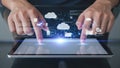 Hands interacting with a holographic cloud technology display on a tablet. Royalty Free Stock Photo