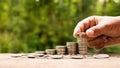 The hands of investors holding coins placed on gold coins at a level different. Royalty Free Stock Photo