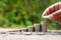 The hands of investors holding coins placed on gold coins at a level different. Royalty Free Stock Photo