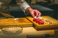 hands of japanese omakase chef preparing sashimi raw fish at counter Royalty Free Stock Photo