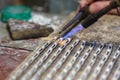 Hands of jeweller at work silver soldering Royalty Free Stock Photo