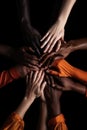 Hands joined in a gesture of collaboration, teamwork among different ethnicities.