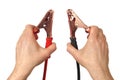 Hands with jumper cables on white Royalty Free Stock Photo