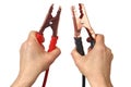 Hands with jumper cables on white Royalty Free Stock Photo