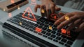 Hands on keyboard with digital security alerts and warnings on laptop screen, emphasizing system vulnerabilities in Royalty Free Stock Photo