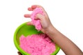 Hands of a kid playing with pink magic sand Royalty Free Stock Photo