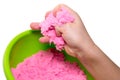 Hands of a kid playing with pink magic sand Royalty Free Stock Photo