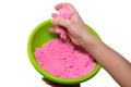 Hands of a kid playing with pink magic sand Royalty Free Stock Photo