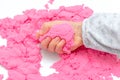 Hands of a kid playing with pink magic sand Royalty Free Stock Photo