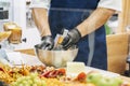 Hands of kitchen chef. Grating cheese with grater, selective focus of raw ingredients Royalty Free Stock Photo