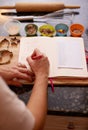 Hands, kitchen and writing in book for recipe in countertop for dinner, seasoning and flavor at home. Person Royalty Free Stock Photo