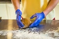 Hands knead dough with gloves Royalty Free Stock Photo