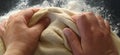 Hands knead the dough. The woman kneaded dough for baking or dumplings. Preparation of flour, water and egg mass for thermal