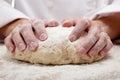 Hands kneading bread dough