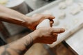 hands kneading bread dough on a cutting board. knead the pizza dough. ball of dough in male hands Royalty Free Stock Photo