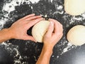 Hands kneading dough on black board Royalty Free Stock Photo