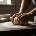 Hands kneading dough on a floured wooden table, preparing for baking, artisan bread making concept. Royalty Free Stock Photo