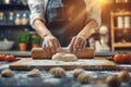 Hands kneading dough, rolling pin for dough, bakery and bakehouse