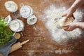 Hands kneading homemade dough wooden table and flour in kitchen