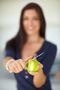 Hands, knife and woman peeling apple for food, eating organic vegan snack and vitamin c. Closeup, cutting skin on fruit