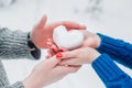 Hands in knitted mittens with heart of snow in winter day. Love concept. Valentine day background. Royalty Free Stock Photo