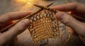 Hands knitting with brown yarn closeup Royalty Free Stock Photo