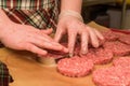 Hands kooking burger cutlets close up