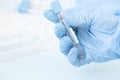 Hands of a lab technician with a tube of blood sample , lab assistant holds a blood test tube for research. Royalty Free Stock Photo