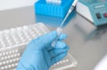 Hands of a lab technician with a tube of blood sample and a rack with other sampl Royalty Free Stock Photo