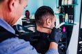 Hands of latin man stylist cutting hair to a client in a barber shop in Mexico Royalty Free Stock Photo