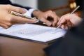 Hands of lawyer pointing at paper for businessperson signing contract. Solicitor, legal advisor helping mature client to Royalty Free Stock Photo