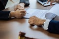 Hands of lawyer pointing at paper for businessperson signing contract. Solicitor, legal advisor helping mature client to Royalty Free Stock Photo