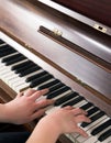 Hands learning to play piano at home in a calm atmosphere. Person composing relaxing classical music using a musical Royalty Free Stock Photo