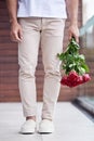 Hands, legs and man with bouquet of roses for date, romance and hope for valentines day. Love confession, romantic