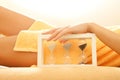 Hands and legs in spa salon with a sandglass Royalty Free Stock Photo