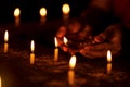 Hands Light Up Candles At Night