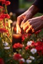 Hands lighting candle between flowers on graves. Generative Ai.