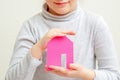 Child is holding paper pink house Royalty Free Stock Photo