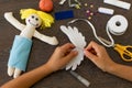 Hands of little girl making a rag doll Royalty Free Stock Photo