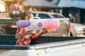 Hands of little girl shooting a water gun to general public in the Songkran festival. Royalty Free Stock Photo