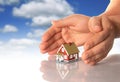 Hands and little house. Royalty Free Stock Photo
