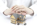 Hands and little yellow house Royalty Free Stock Photo