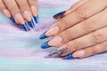 Hands with long artificial blue french manicured nails Royalty Free Stock Photo