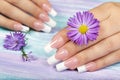 Hands with long artificial french manicured nails