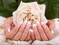 Hands with long artificial french manicured nails