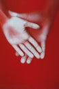 Hands of a loving couple pressed with palms to glass in red water, a man protects a woman, concept love and feelings, mysterious Royalty Free Stock Photo