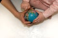 Hands of mother and child holding a globe Royalty Free Stock Photo